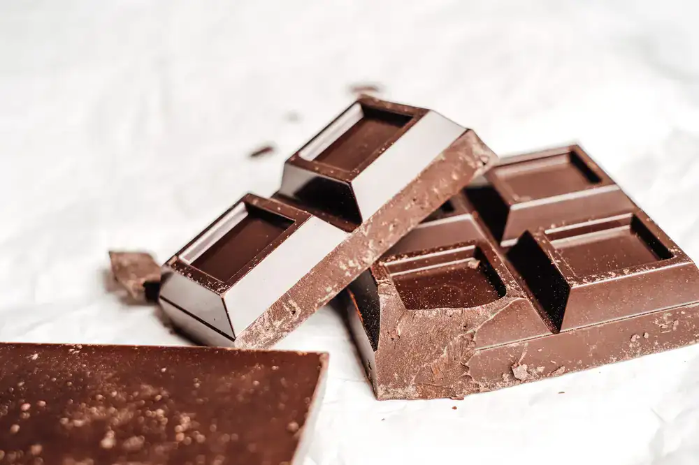 Chocolatier tempering chocolate on a marble slab