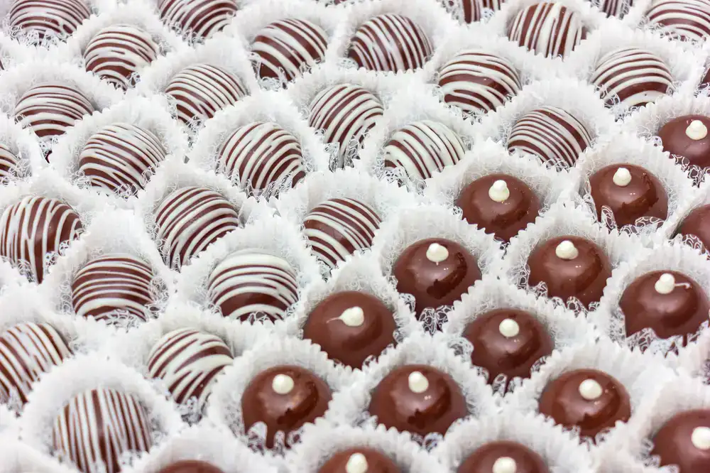 Close up view of glossy artisan chocolates in a row
