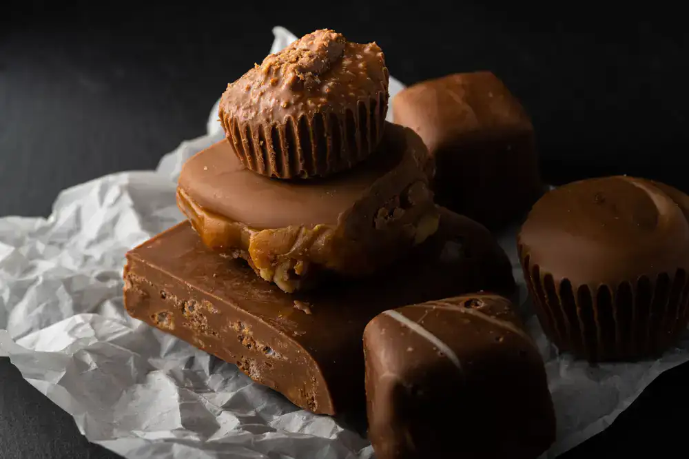 Glossy artisan chocolates arranged elegantly on a dark stone surface